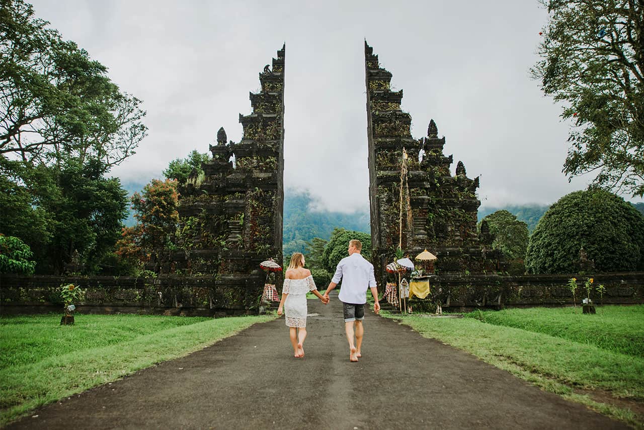 Couple walking through the iconic Handara Gate in Bali